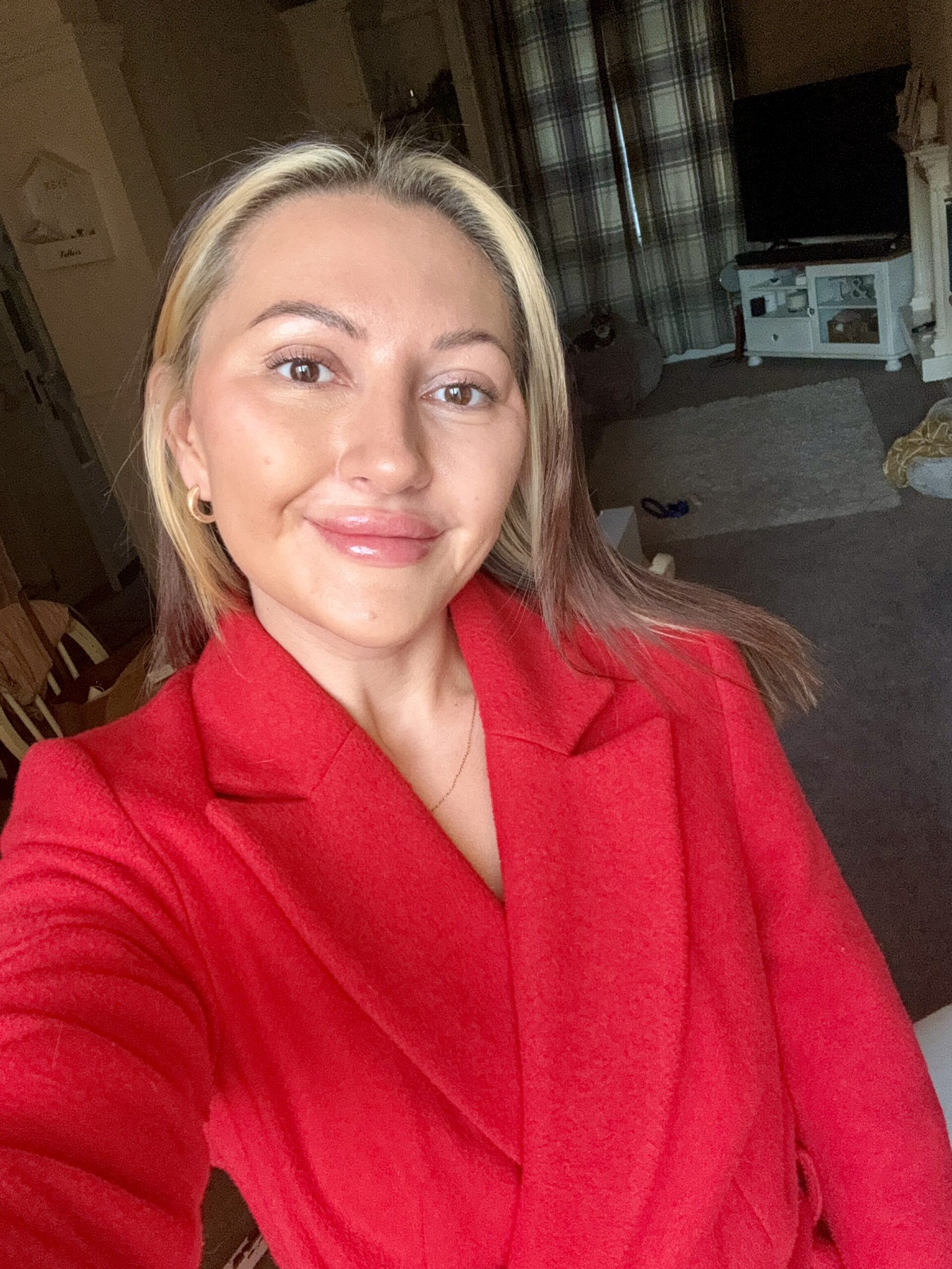 Picture of a smiling woman in a red suit